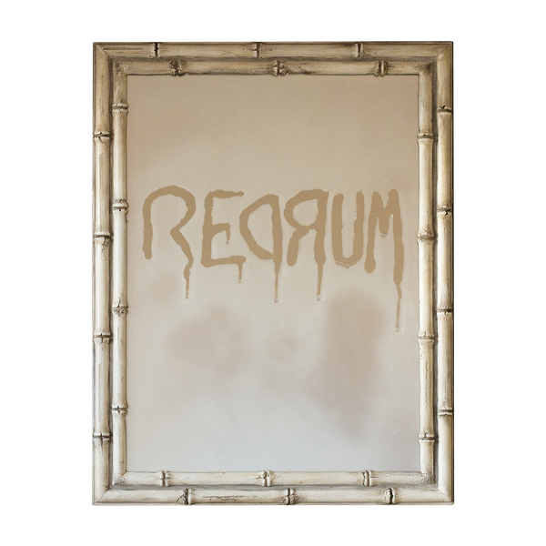 To celebrate Halloween, we made a mirror with frosted glass that says "redrum" and framed it in a style that looks like it's made of old bones. 