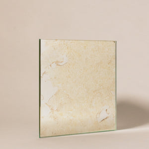 A Vincenzo mirror glass sample photographed at an angle on a white background.