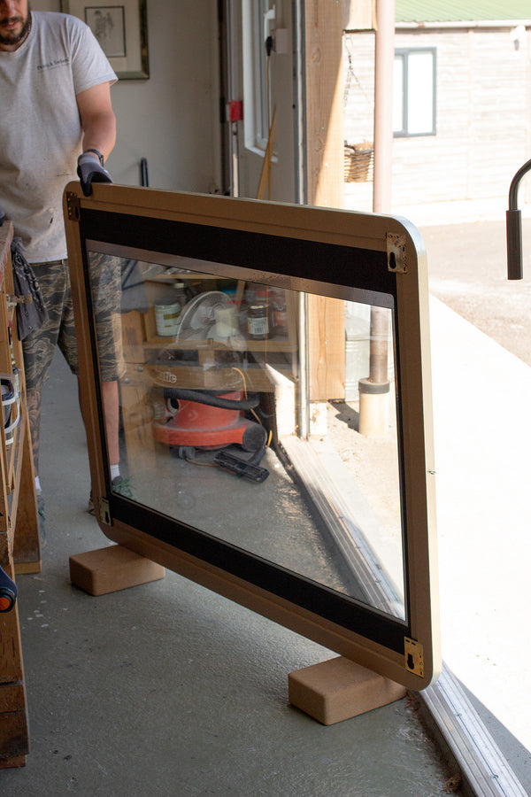 The back of a large rectangular TV mirror made using dielectric mirror glass, which is transparent. 